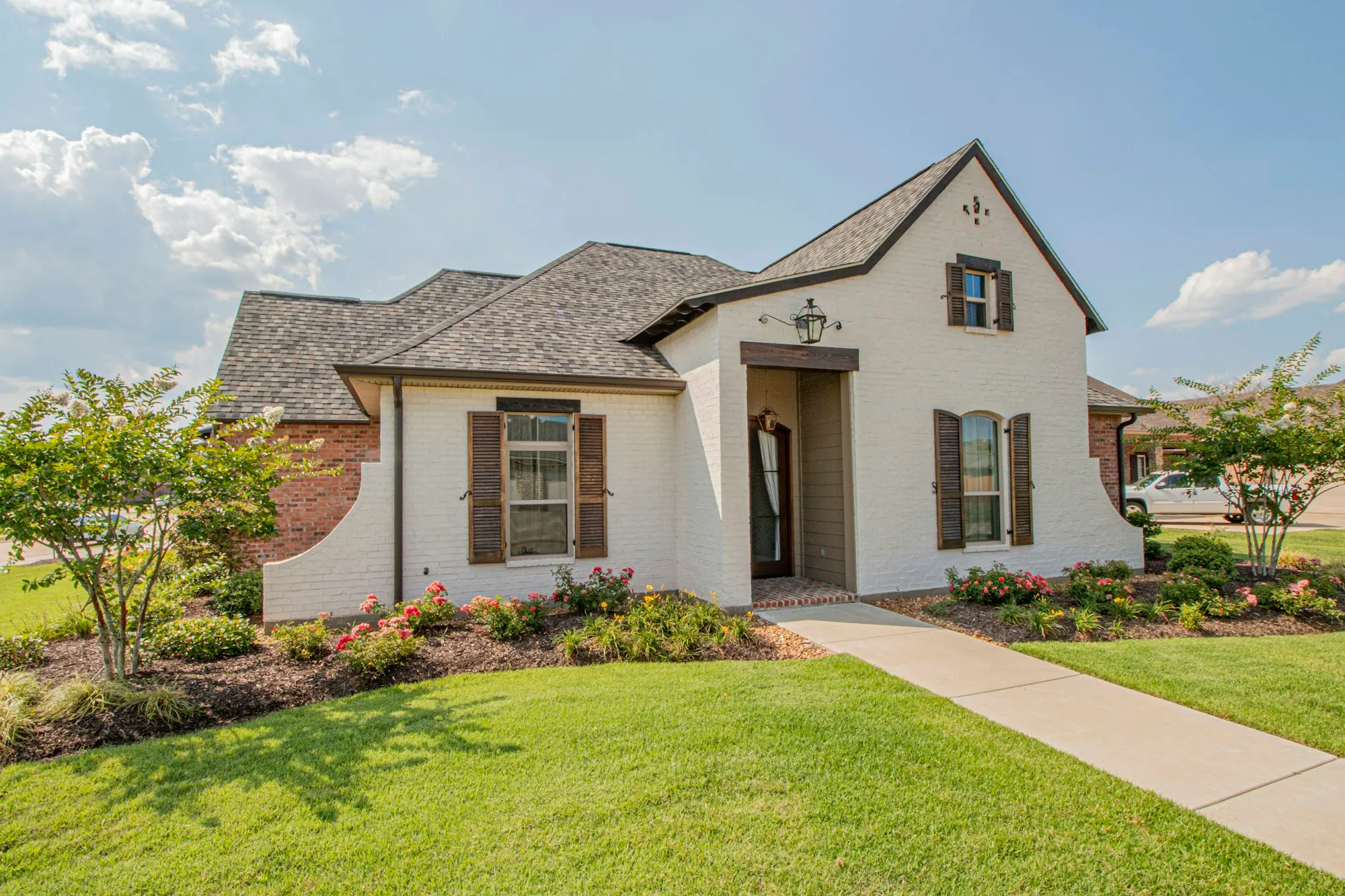Newly built suburban American home with fresh landscaping in a master-planned community