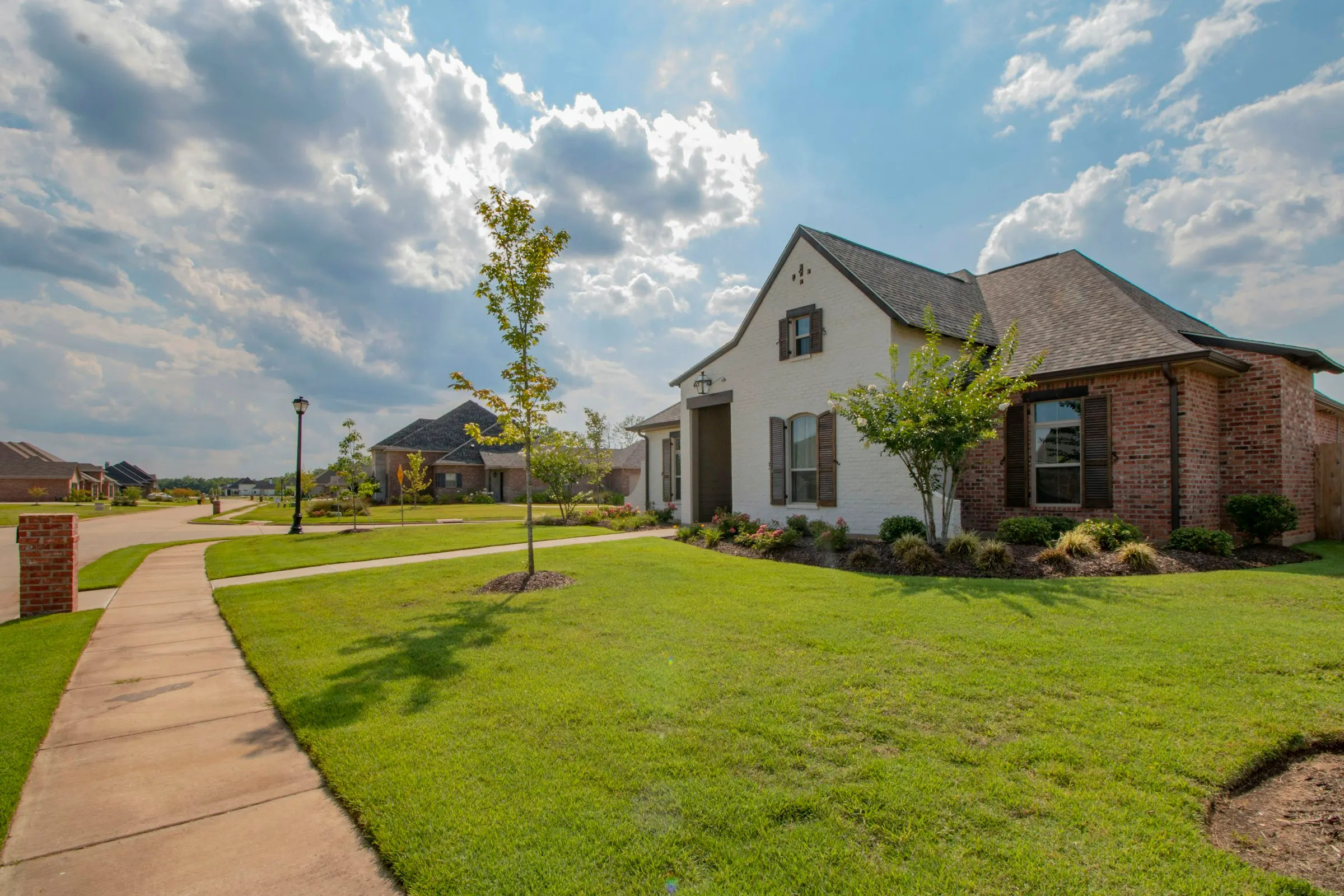 Classic American family home with a front lawn and covered porch in an established neighbourhood