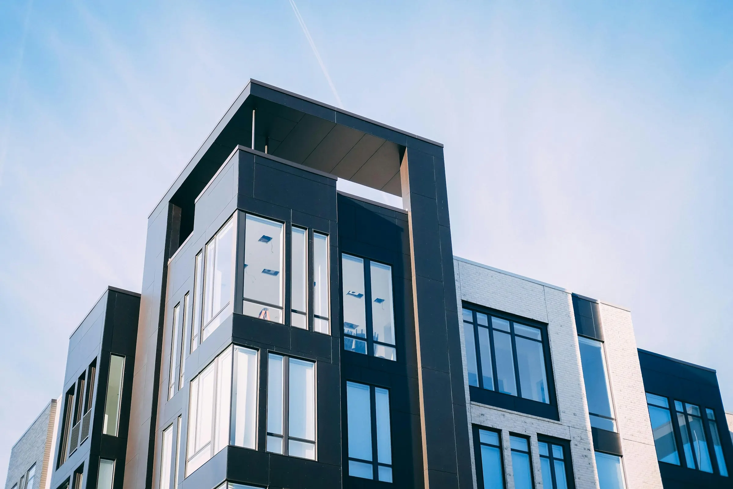 Modern apartment building exterior representing rental and leasing property management services