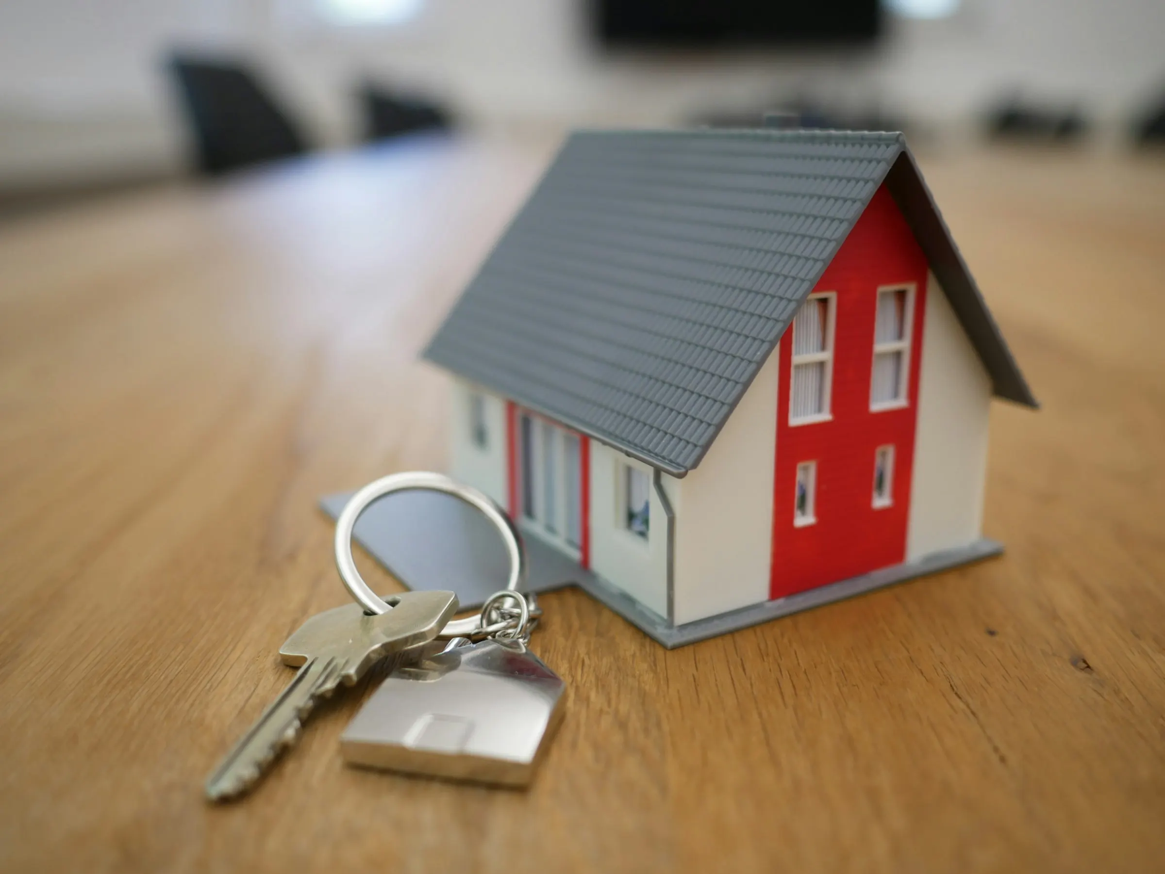 Real estate agent handing over house keys to new owners at closing